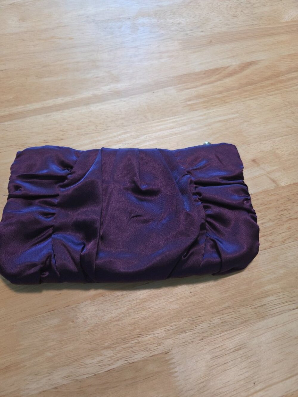 Purple satin clutch bag.